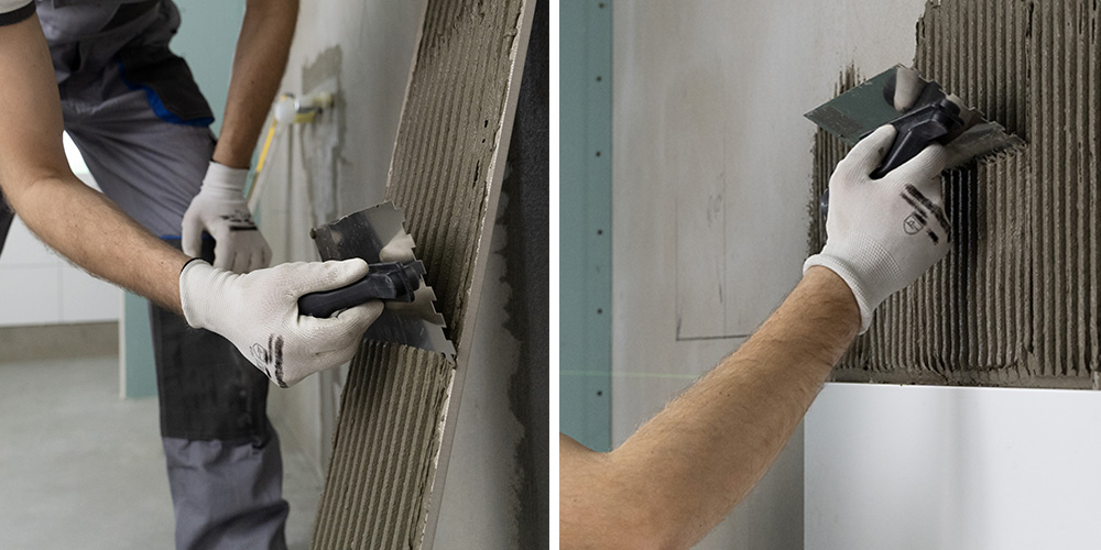 Man applying tile adhesive to a wall using a an adhesive trowel
